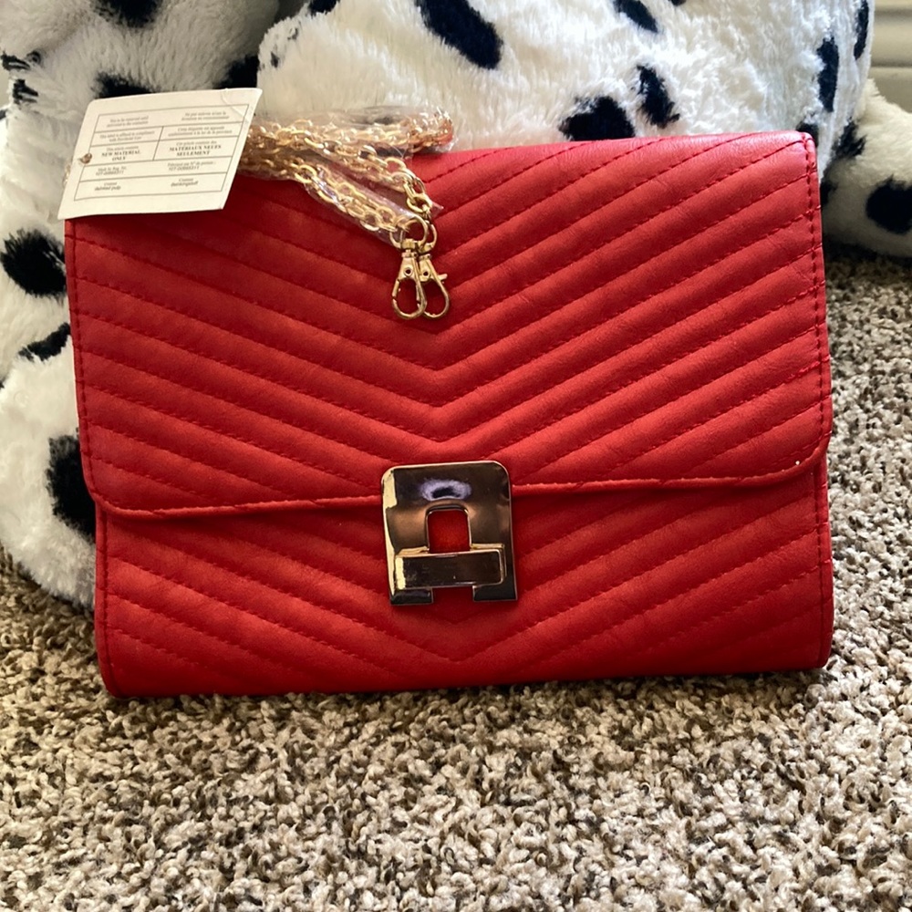 Never worn, red, detachable gold strap, clutch purse.